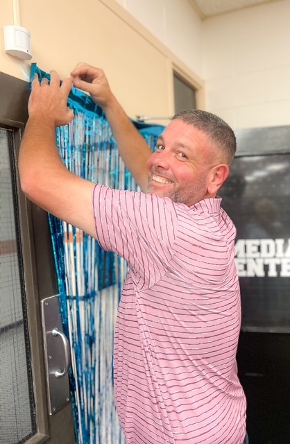 Blue balloons and confetti with text: ‘Today we celebrate with a BLUE party! Elizabethtown Middle School exceeded growth for 2024–2025.’