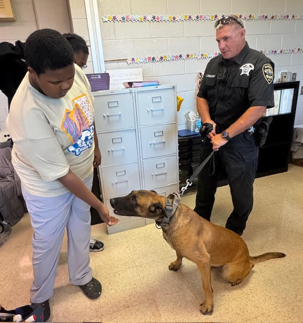 🐾 Special Visit from the K-9 Unit 🐾 Last week, our students in Mrs. Jones’ class had an exciting opportunity to meet a K-9 officer and his dog, Orex! 🐕🚔 The students learned about the important role K-9 officers like Orex play in keeping our community safe and even got to see him in action. It was an engaging and memorable experience for everyone! 🏰💜 #WestBladenKnights #CommunityPartners #K9Unit #Orex #GoKnights