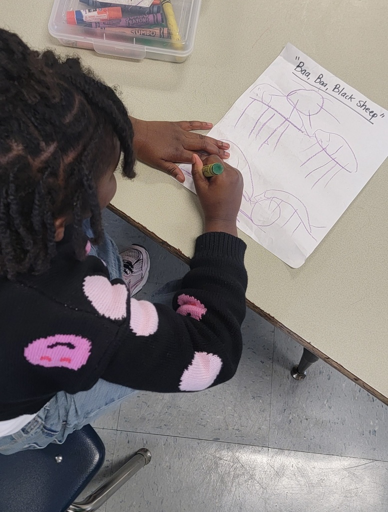 Student points to sheep in their “Baa Baa Black Sheep” drawing.