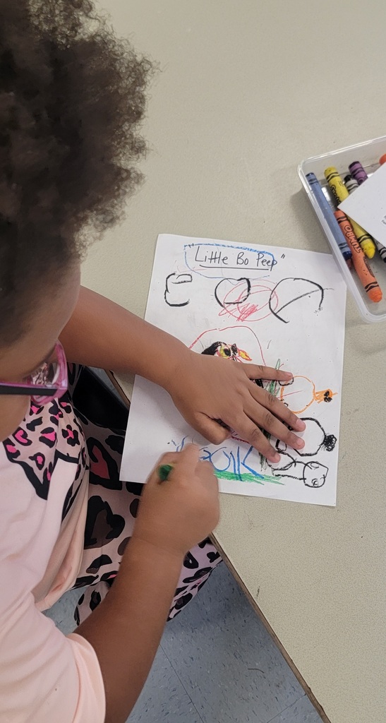 Student colors a “Little Bo Peep” picture with sheep and bright colors.