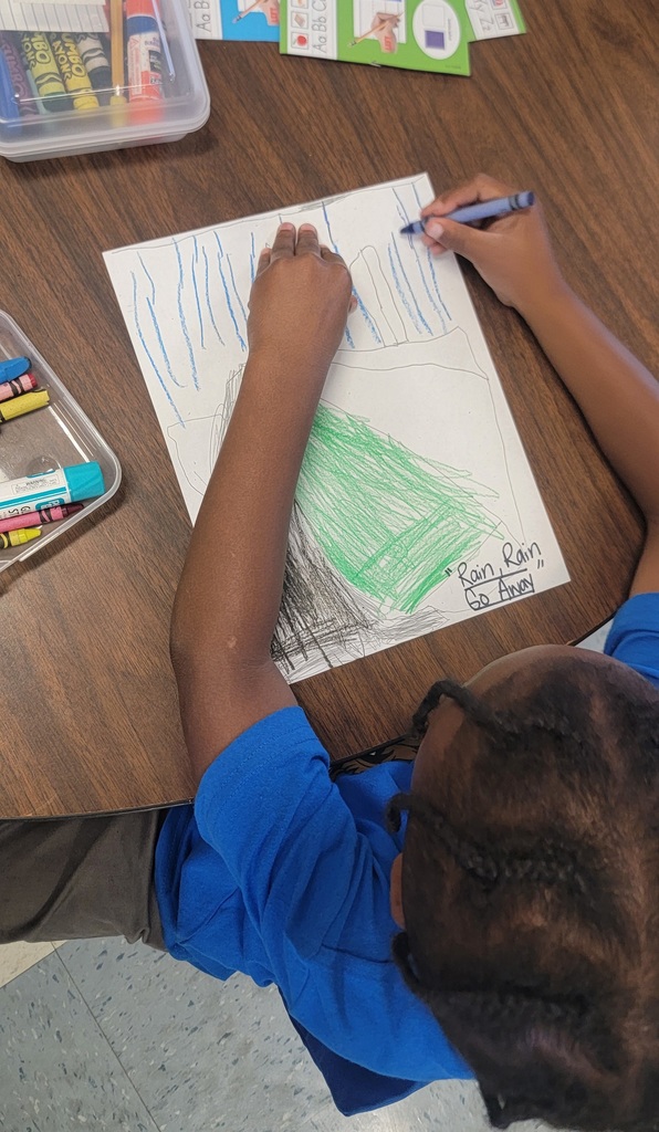 Student colors “Rain Rain Go Away” picture with blue rain and green grass.