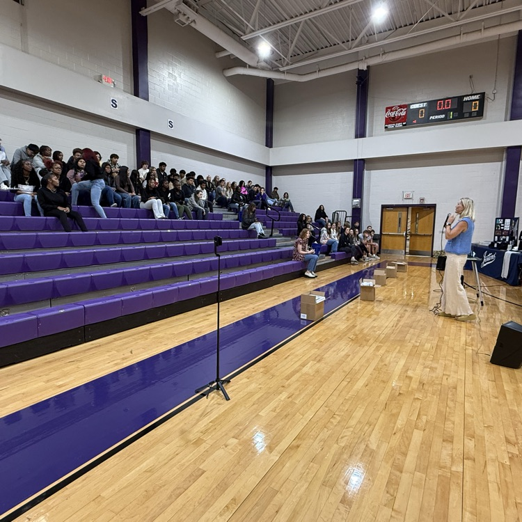 jostens representative speaking with junior class in the gym