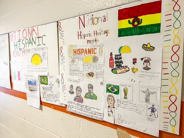 Student posters with flags, foods, and cultural symbols celebrate Hispanic Heritage Month on display at Elizabethtown Middle School.