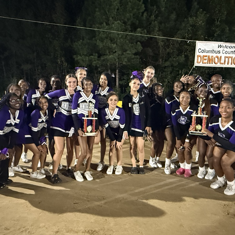 cheerleaders posing with trophy
