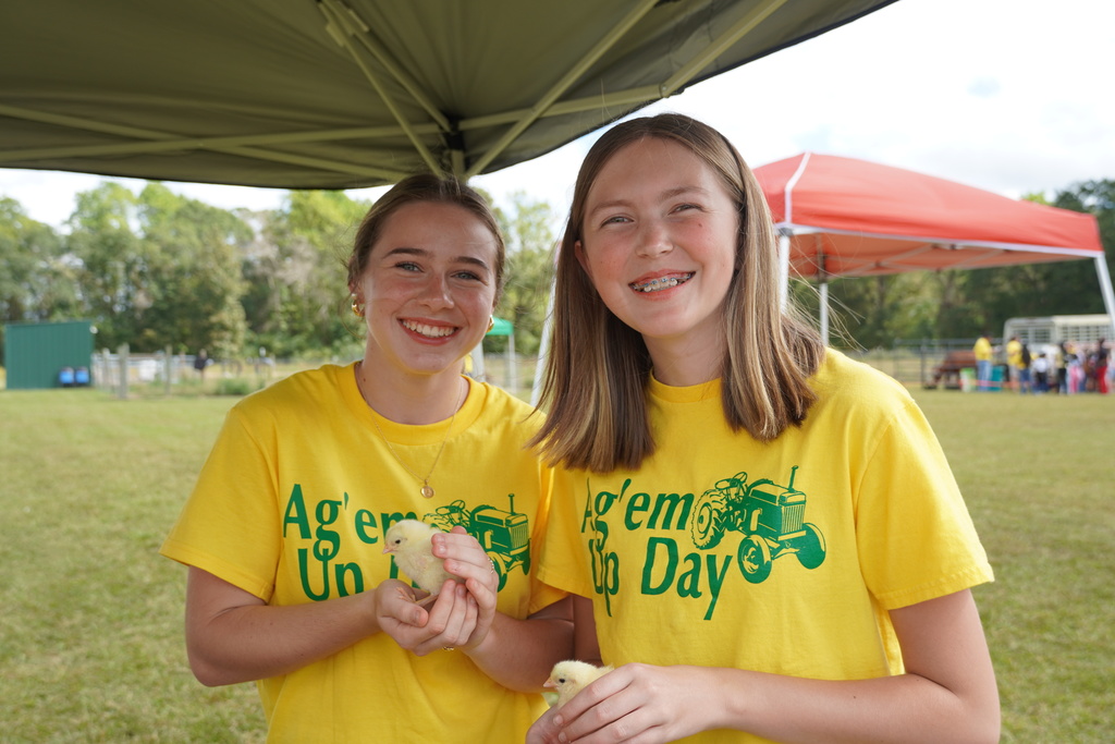 Students participate in hands-on agriculture activities during Ag ‘Em Up Day, learning about farm equipment, animals, and crop production.
