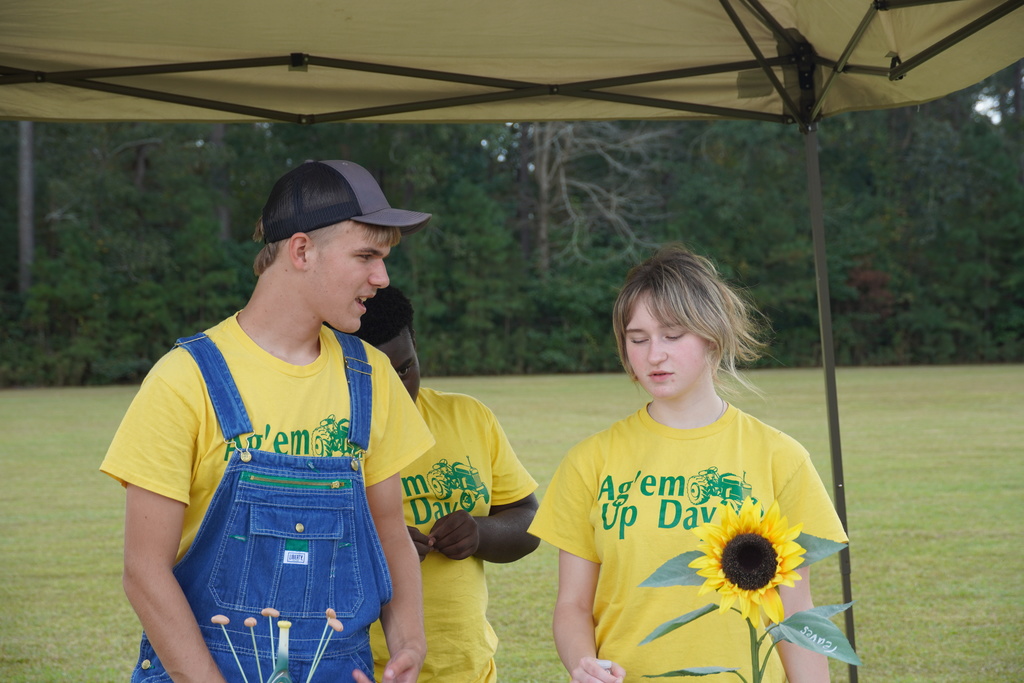 Students participate in hands-on agriculture activities during Ag ‘Em Up Day, learning about farm equipment, animals, and crop production.
