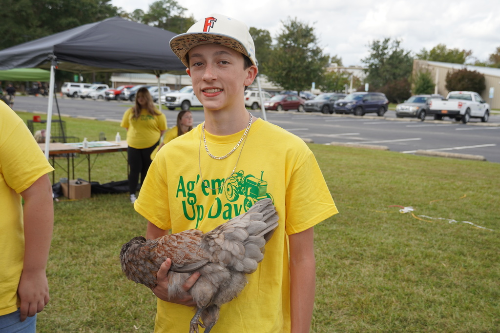 Students participate in hands-on agriculture activities during Ag ‘Em Up Day, learning about farm equipment, animals, and crop production.