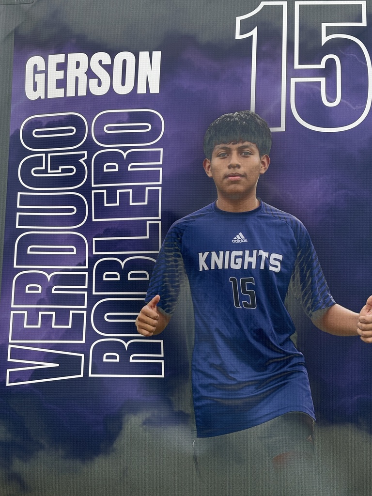 A soccer banner featuring a West Bladen player wearing a blue Knights jersey with the number 15. The banner includes the player’s name, “Gerson Verdugo Roblero,” displayed in bold white and purple letters on a stormy purple background with lightning accents. The player is giving two thumbs up and looking toward the camera.