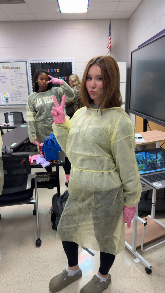 Students learning to wear PPE.