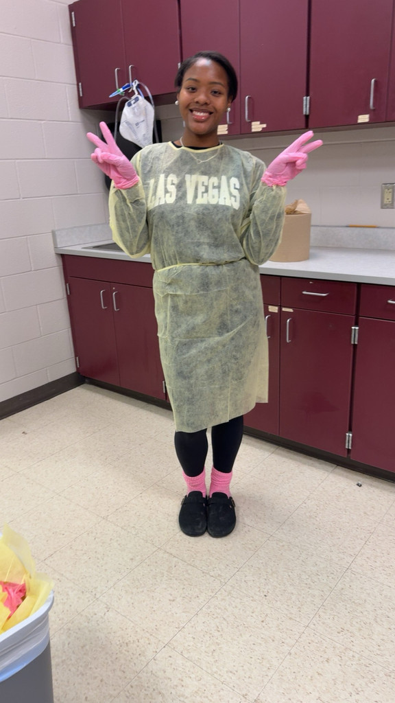 Students learning to wear PPE.