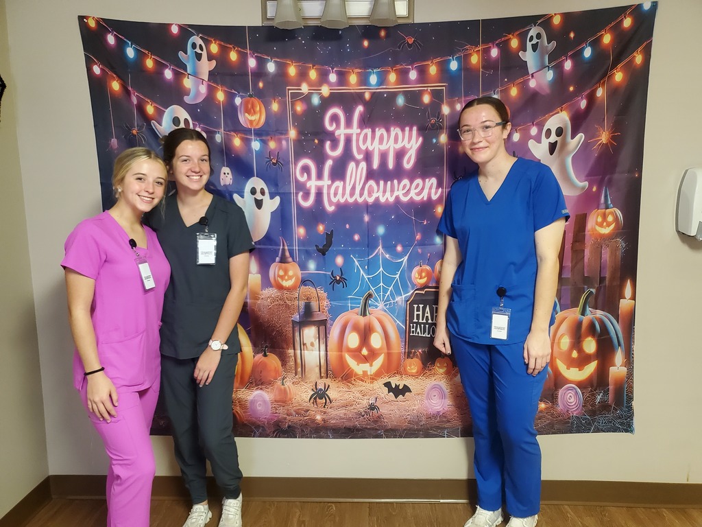 nurse aid students posing with happy haloween sign