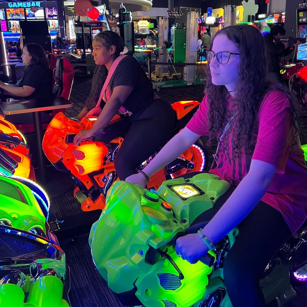 female students playing racing game