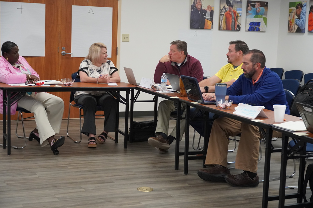 School leaders engaged in collaborative discussion during breakout session
