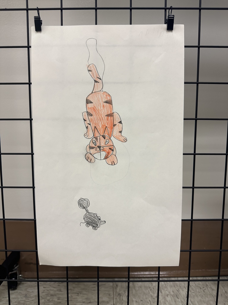 A hand-drawn orange tiger positioned in the center of a large sheet with a small sketch of a toy cart below it.