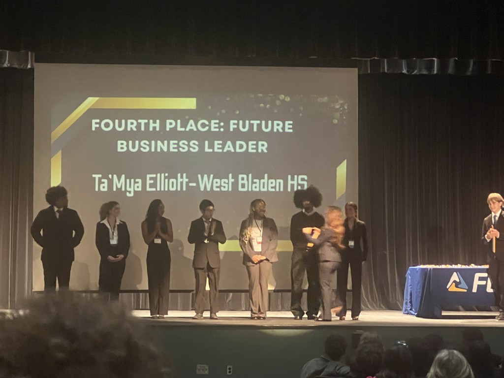 Ta'Mya Elliott from West Bladen HS is awarded Fourth Place: Future Business Leader on stage with others.