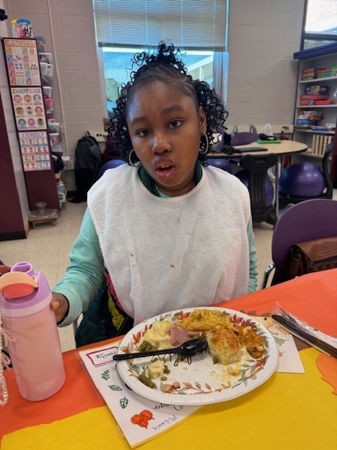a female student eats a thanksgiving lunch