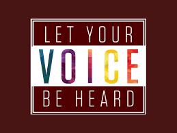 A graphic with a dark red background featuring a white rectangular border. Inside the box, large bold text reads “LET YOUR VOICE BE HEARD.” The word “VOICE” is highlighted in multicolored letters, while the rest of the text is white.