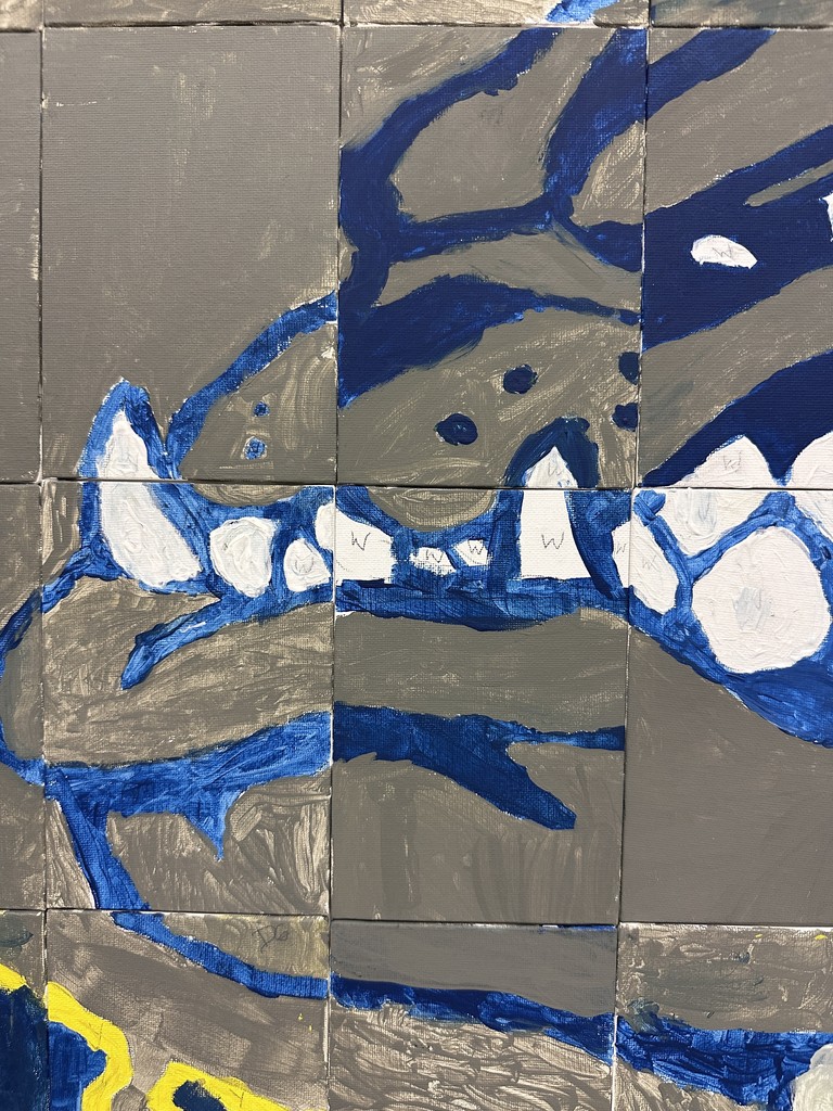Section of a bulldog mural showing blue and white painted shapes and outlines across gray canvas tiles in an abstract style.