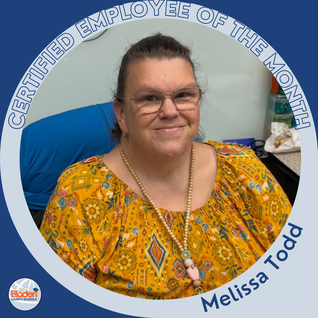 A woman wearing glasses and a yellow patterned blouse smiles while seated at a desk. A beaded necklace hangs around her neck. The circular frame reads ‘Certified Employee of the Month – Melissa Todd,’ with the Bladen County Schools logo in the corner.