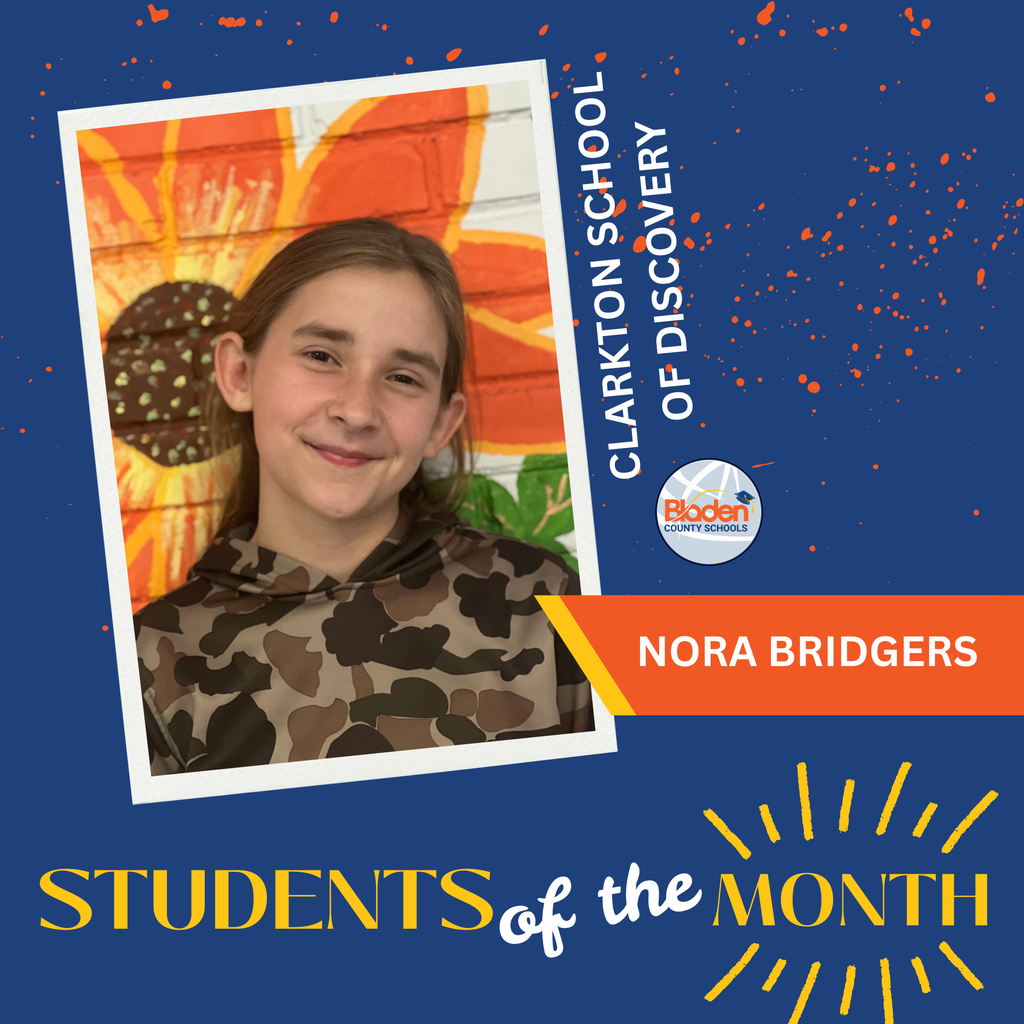 A student with long light-brown hair wearing a camouflage-patterned hoodie smiles while standing in front of a brightly painted mural of a large orange flower. The graphic reads “Clarkton School of Discovery” and “Nora Bridgers” with a “Students of the Month” banner.
