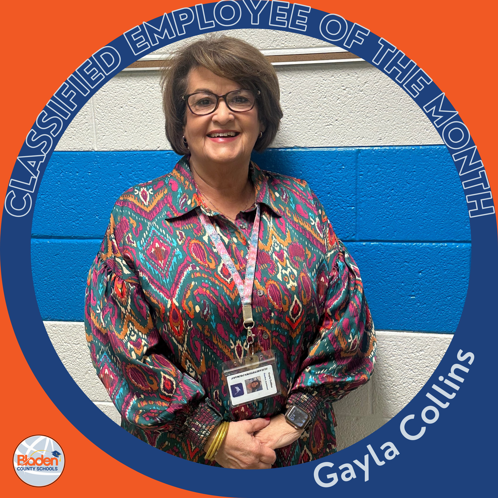 Circular ‘Classified Employee of the Month’ graphic featuring a woman smiling while standing against a blue-and-white painted wall. She is wearing glasses and a colorful patterned blouse with an ID badge on a lanyard. Text on the graphic reads ‘Gayla Collins.