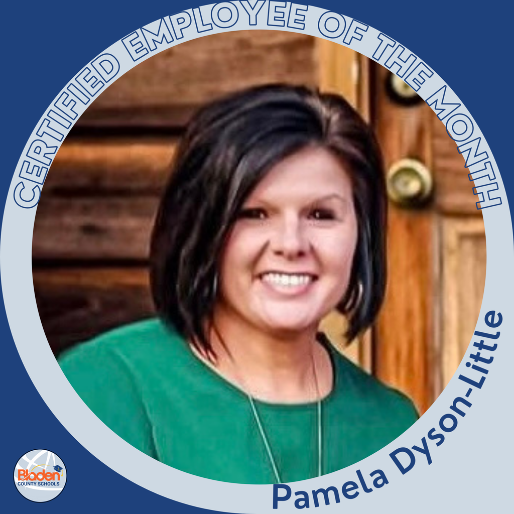 A woman with short dark hair smiles while posing in front of a wooden door. She is wearing a green top and a long necklace. The circular frame reads ‘Certified Employee of the Month – Pamela Dyson-Little,’ with the Bladen County Schools logo in the corner.