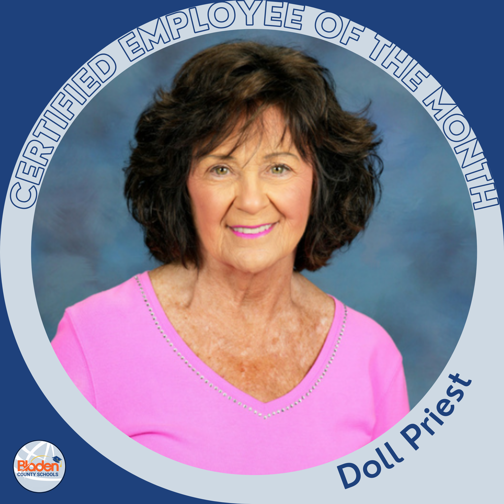 Circular ‘Certified Employee of the Month’ graphic featuring a woman smiling in front of a soft blue background. She has short curly brown hair and is wearing a bright pink top. Text on the graphic reads ‘Doll Priest.