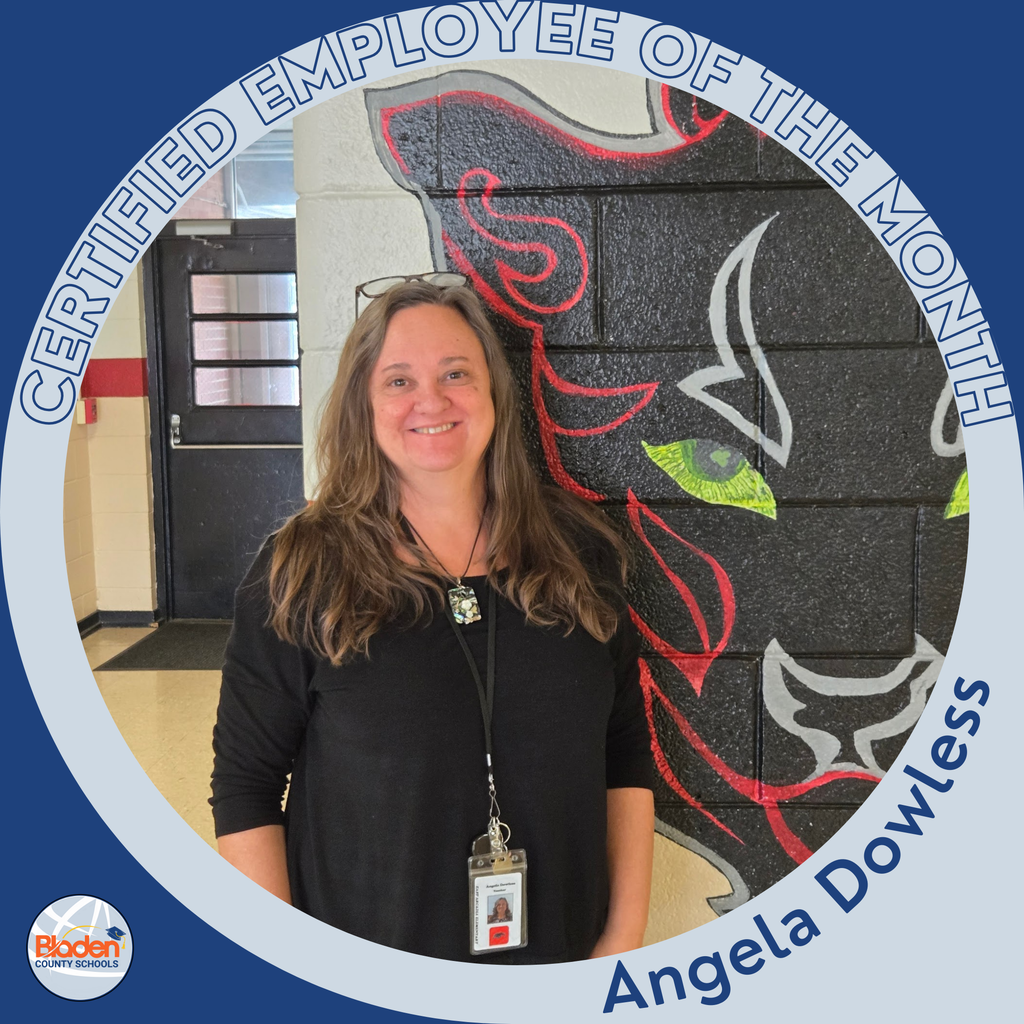 Circular ‘Certified Employee of the Month’ graphic featuring a woman smiling while standing in front of a school mural of a stylized panther with green eyes. She is wearing a black top and an ID badge. Text on the graphic reads ‘Angela Dowless.