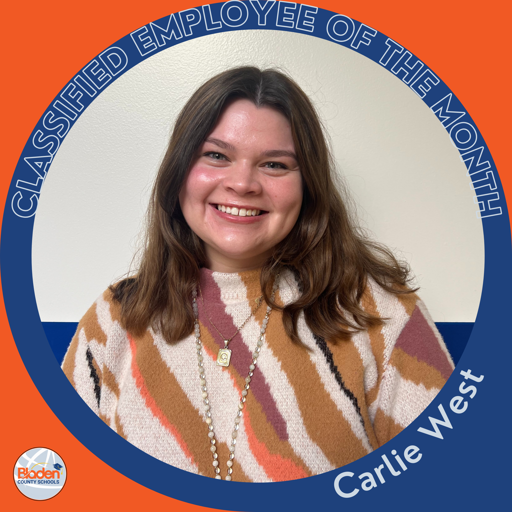 Circular graphic featuring a woman smiling in front of a plain wall, wearing a patterned sweater and layered necklaces. The border reads “Classified Employee of the Month,” and the name “Carlie West” is written along the bottom. A Bladen County Schools logo is in the lower-left corner.