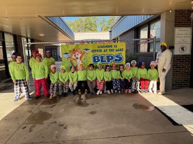 Students and principal in their BLPS toboggans and shirts smiling