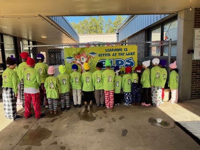 Students showing off the back of their BLPS shirts
