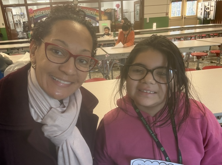 district administrator and student smile for photo in cafeteria