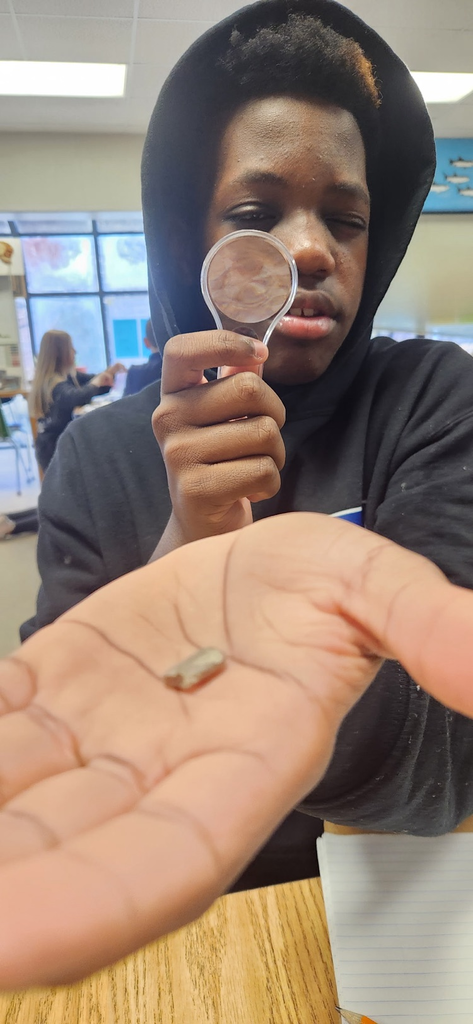 student holding microscope
