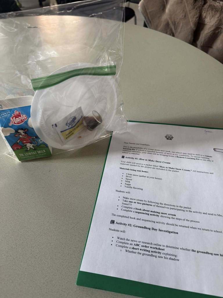 A photo of a snow cream kit including a carton of milk, sugar packets, and a plastic bag, next to an instruction sheet titled "How to Make Snow Cream" on a countertop.