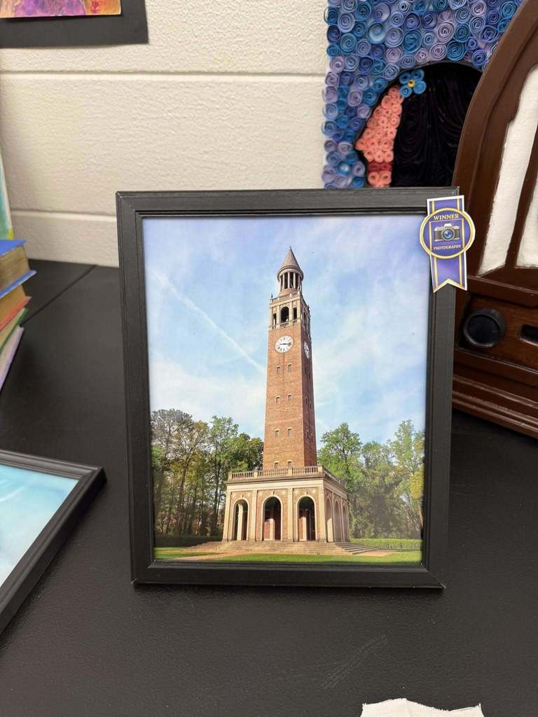Framed photograph of a tall brick clock tower with arches at the base, displayed with a blue “Winner – Photography” ribbon.
