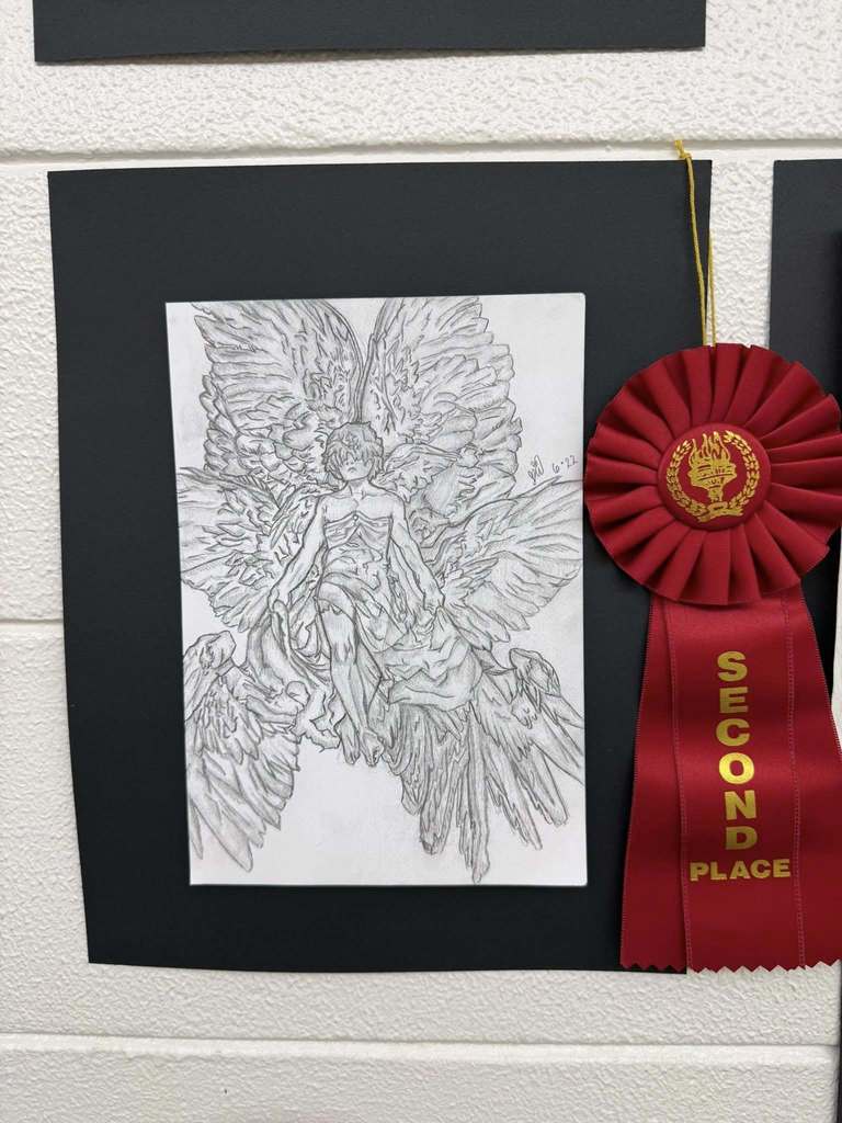 Detailed pencil drawing of a winged angel figure surrounded by layered feathers, displayed with a red “Second Place” ribbon.