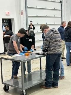 3 students working at a cart