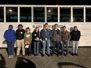 8 students outside a BCS bus