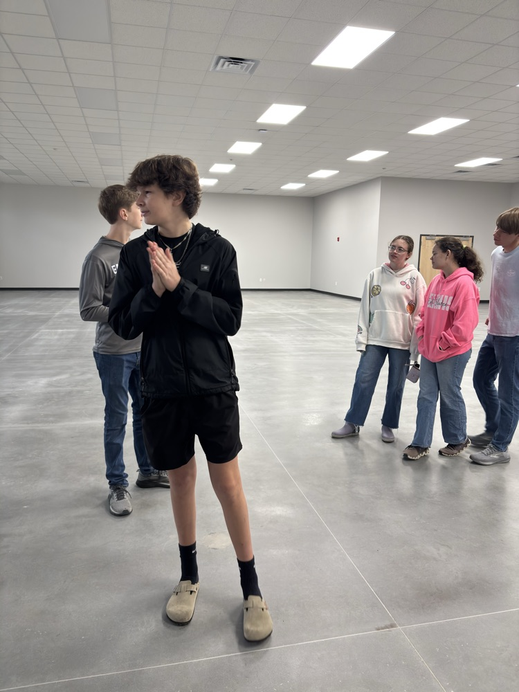5 students standing in the new community center in Elizabethtown.  the building looks newly constructed!