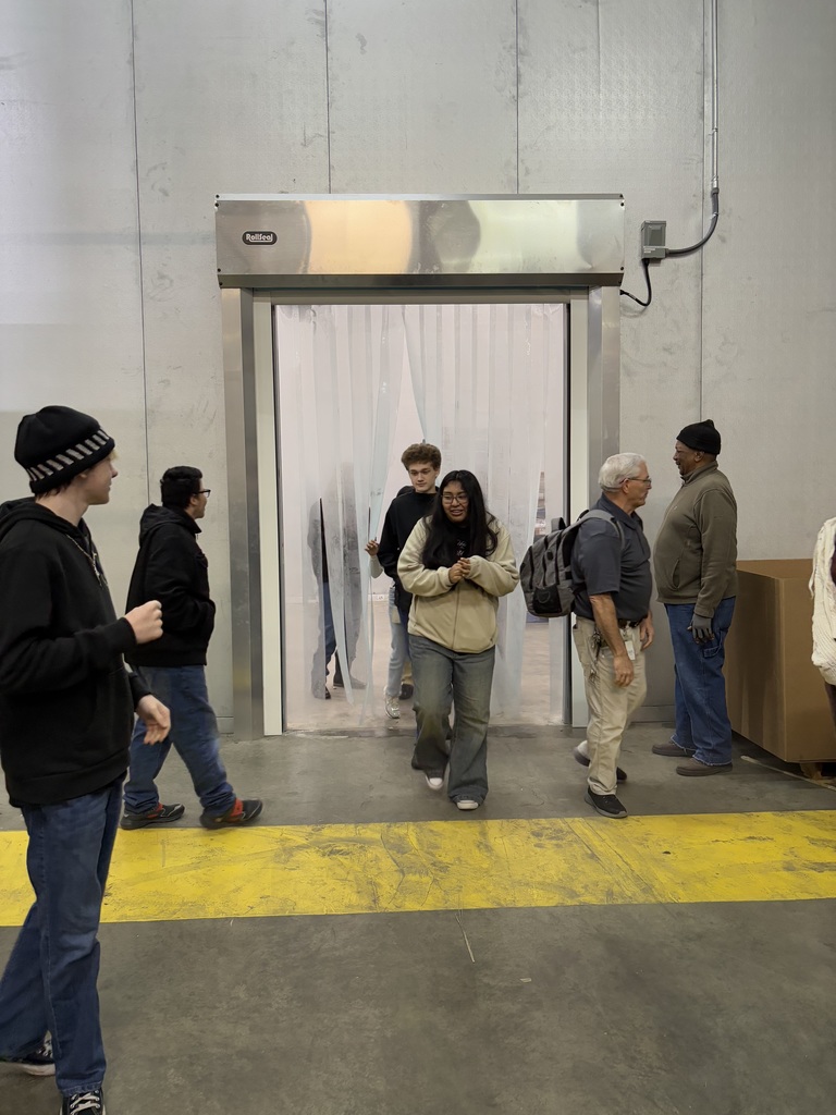 students coming through a door