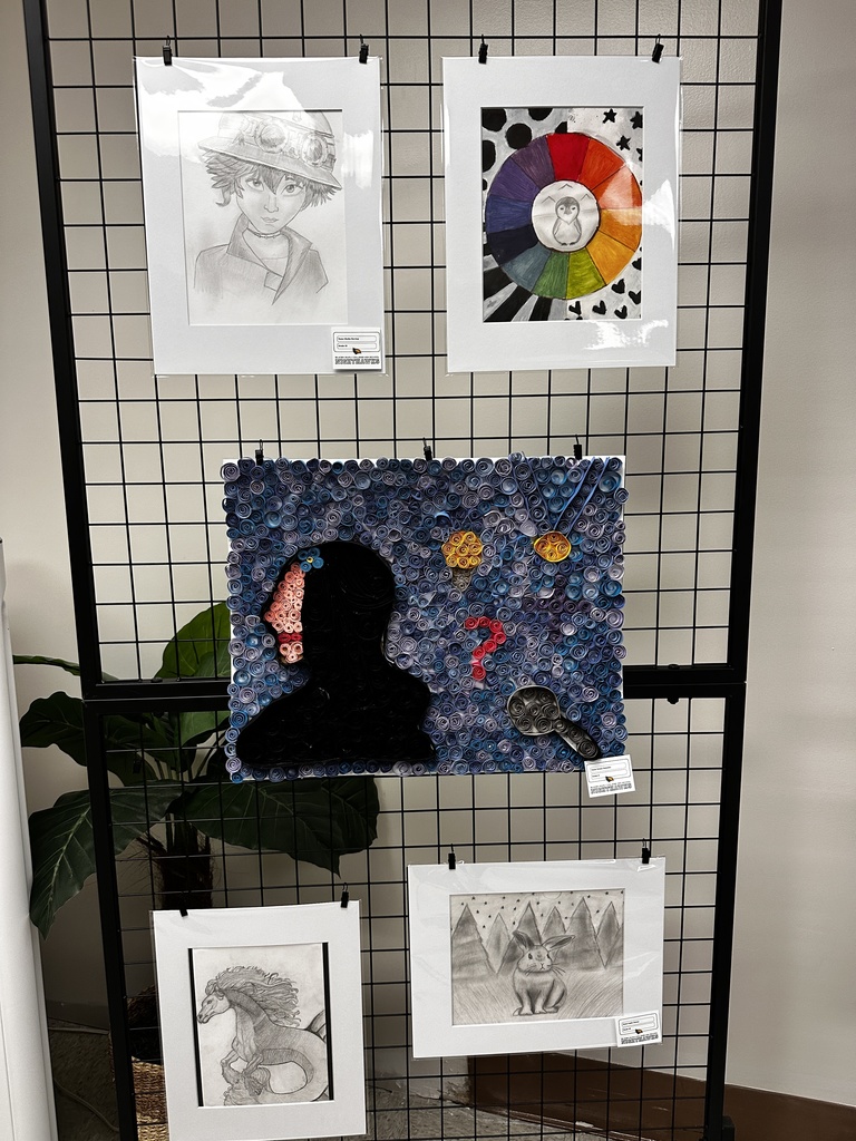 Student art displayed on a black grid panel including pencil drawings of a character, a horse, and a rabbit, a color wheel painting, and a mixed-media piece made from rolled paper forming a silhouette with magnifying glass and question marks.