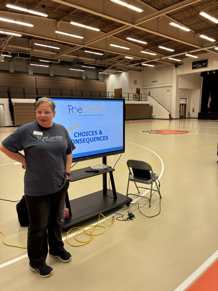 lady in grey shirt talking in front of Cleartouch screen
