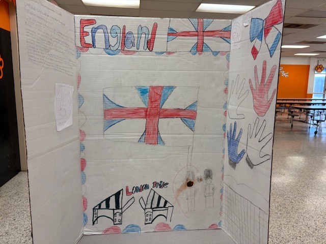Tri-fold presentation board about England showing the English flag and drawings of landmarks such as the London Bridge.