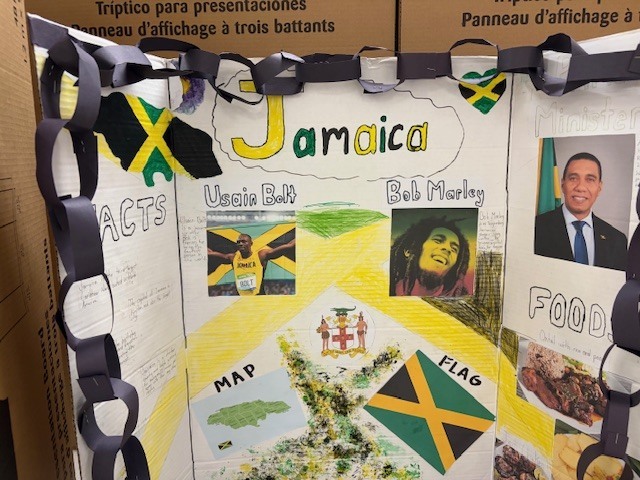 Tri-fold presentation board about Jamaica featuring the Jamaican flag, facts about the country, a map, and images of Usain Bolt and Bob Marley.