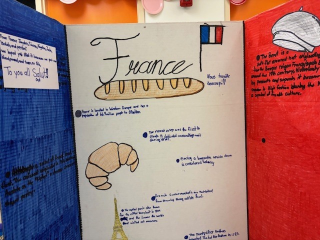 Another France culture project board featuring drawings of French bread, a croissant, and facts about French traditions and history.