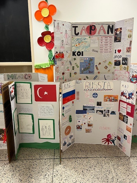 Student cultural projects about Japan, Russia, Mexico, and Turkey displayed on tri-fold boards with maps, pictures, and research about traditions and food.