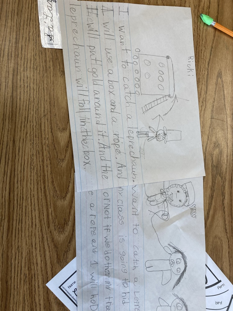 A student’s worksheet shows a hand-drawn design of a leprechaun trap along with written sentences explaining how the trap will work.