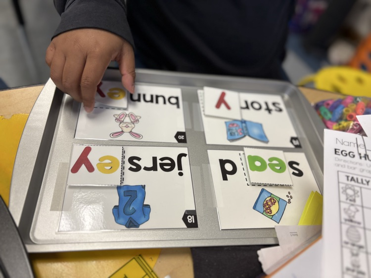 First grade students use magnetic letter tiles to build long vowel E words with vowel teams like ee and ea during a hands-on literacy activity.