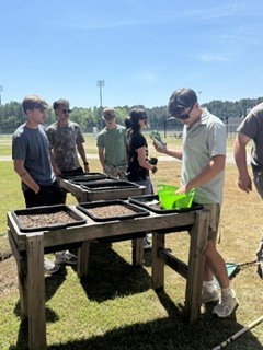 Horticulture kids getting the planters ready to help the Knights of Excellence plant their garden