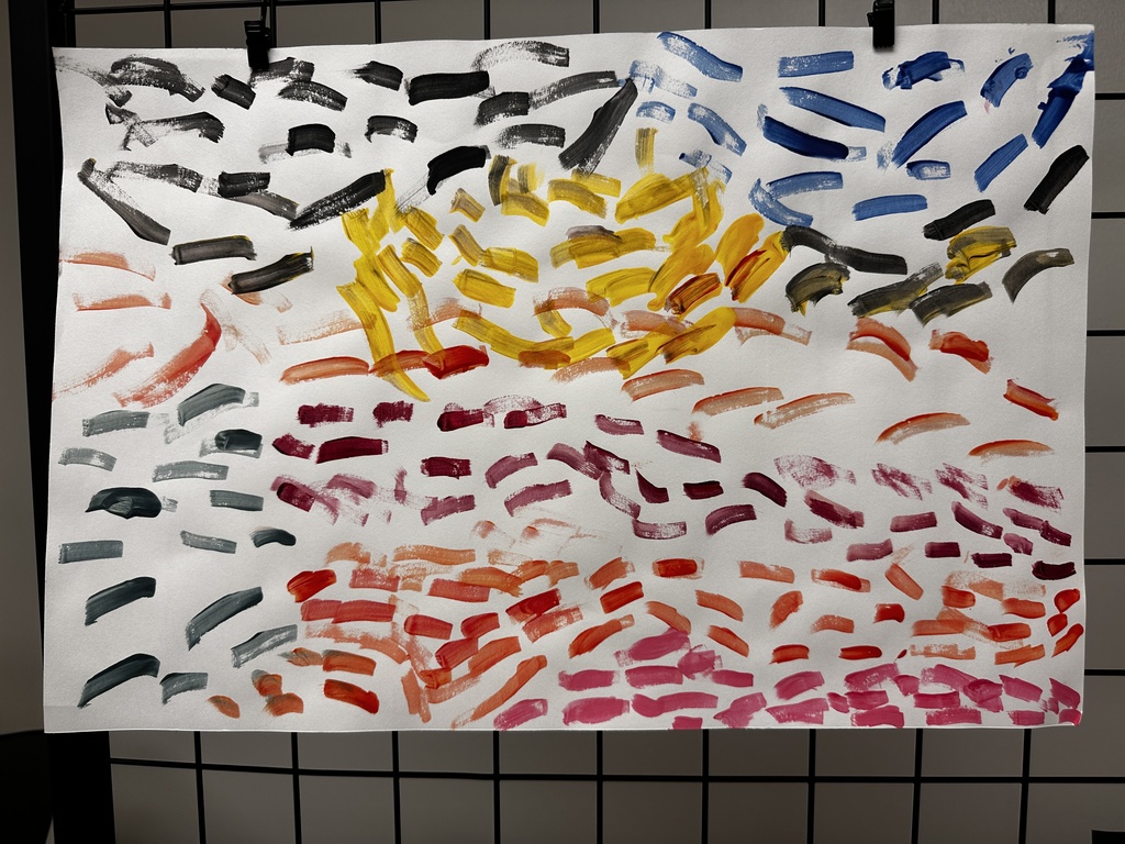 Child's abstract painting of layered brushstrokes in warm and cool tones suggesting a sunset